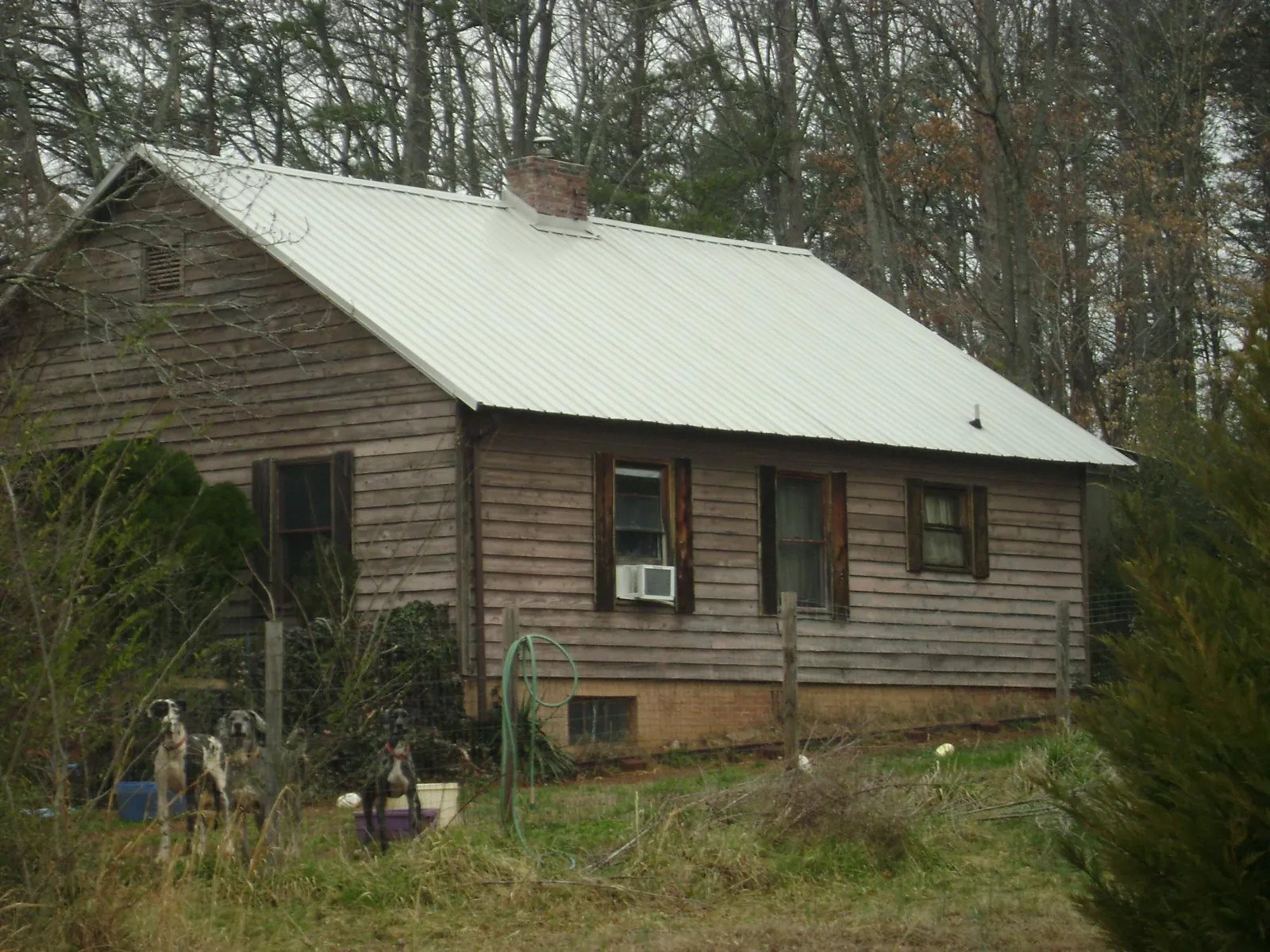 White metal roof on an old wood sided farmhouse, from a Metal Roof Installation job in East Texas